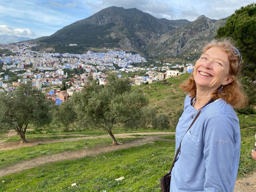 Women smiling with scenery behind her